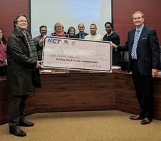 Photo of KCT management team presenting check to local school Photo of KCT management team presenting check to local school