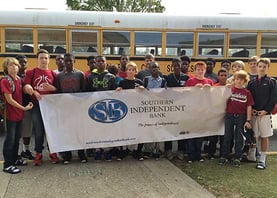 Students Holding Southern Independent Bank Sign