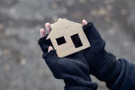 Homeless Person Holding Cardboard House Cutout Homeless Person Holding Cardboard House Cutout