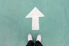 Person Standing in Front of an Arrow Person Standing in Front of an Arrow
