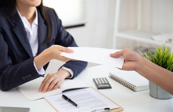 Photo of an Employer Handing Over a Check