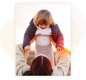 Woman Holding Up Child