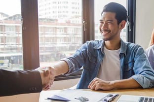 Man Shaking Hands with Bank Employee Man Shaking Hands with Bank Employee