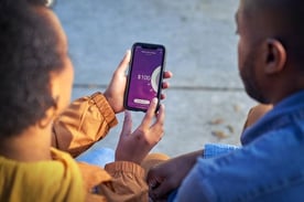 Woman Holding Phone with Earnin App