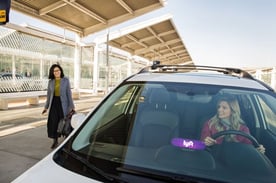 Woman Getting into a Lyft Vehicle Woman Getting into a Lyft Vehicle
