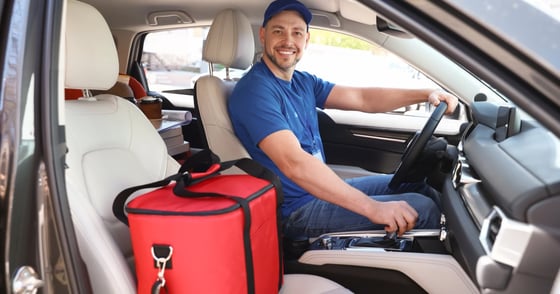 Photo of a delivery driver in a car Photo of a delivery driver in a car