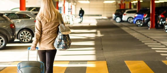 Photo of a woman in an airport parking lot Photo of a woman in an airport parking lot