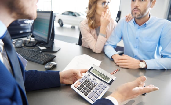 Photo of a shocked couple at a car dealership Photo of a shocked couple at a car dealership