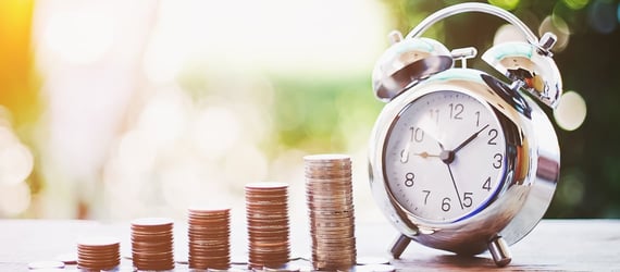 Stacked coins and a clock