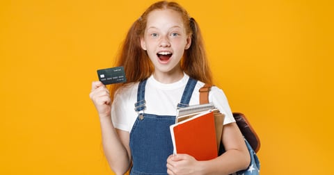 School girl holding a credit card.