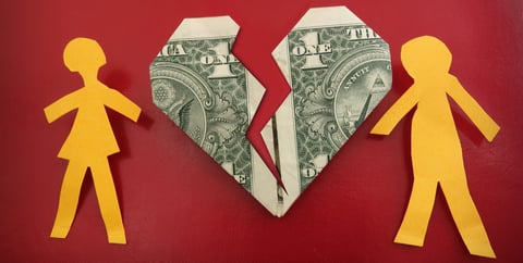 Photo of paper figures and two dollar bills.