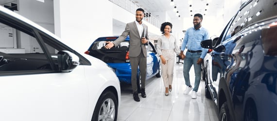 Photo of a couple shopping for a car at a dealership. Photo of a couple shopping for a car at a dealership.