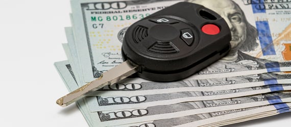 Car keys on top of $100 bills. Car keys on top of $100 bills.