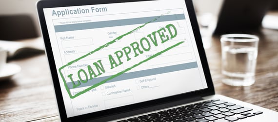 Image of an approved loan application on a laptop. Image of an approved loan application on a laptop.
