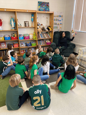 Image of Extra Credit Union reading presentation to students Image of Extra Credit Union reading presentation to students