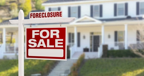 Foreclosure Sign in Front of a Home Foreclosure Sign in Front of a Home