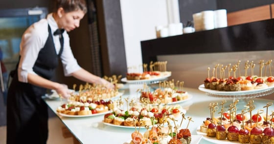 Restaurant waitress serving table with food Restaurant waitress serving table with food