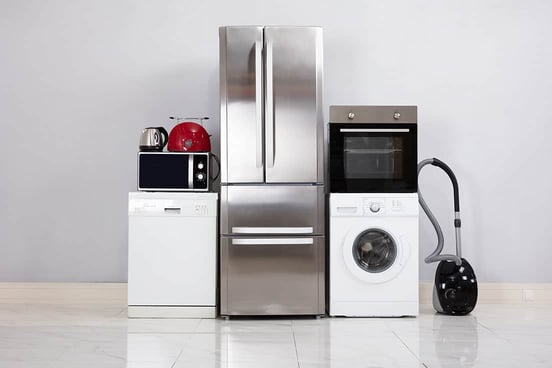 Close-up Of Home Electronic Appliances On Floor Against Grey Wall In New House Close-up Of Home Electronic Appliances On Floor Against Grey Wall In New House