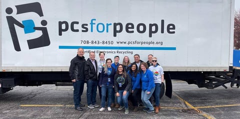Photo of Alliant Credit Union employees in front of PCs for People truck