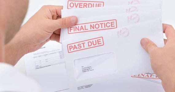 Close-up Of A Man Holding Pending Due Statements