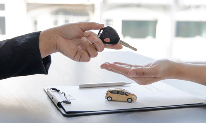 Car dealer handing keys to driver Car dealer handing keys to driver