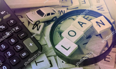 Image of a calculator and wooden blocks with the word LOAN