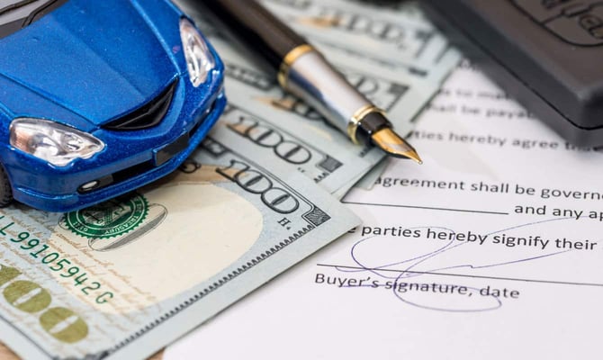 Image of a toy car with money and a signature Image of a toy car with money and a signature