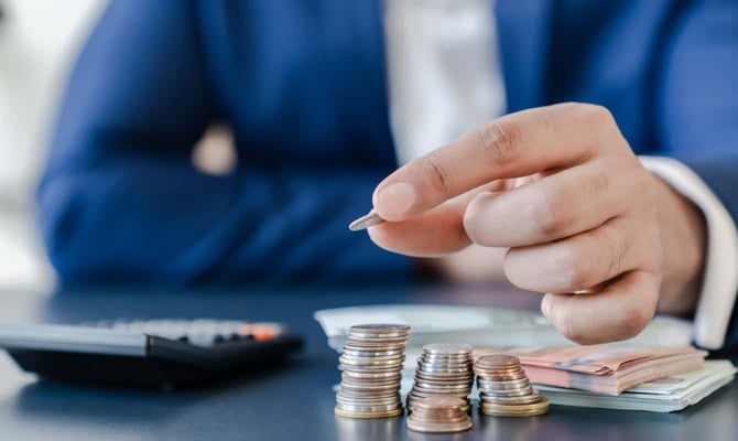 Man placing coins on a table Man placing coins on a table