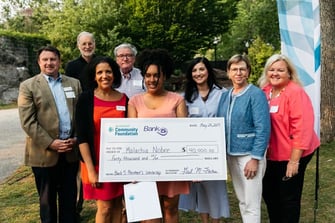 scholarship winner with large check scholarship winner with large check