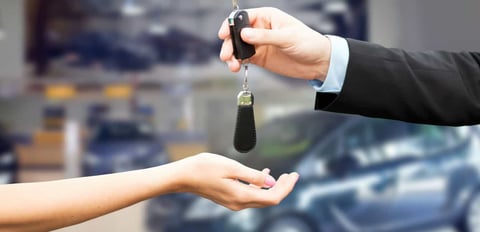 transferring car keys in a car dealership