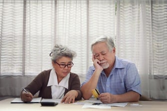 Senior Couple Look at Credit Card