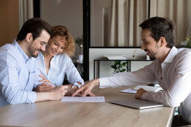 Photo of a Mortgage Lender with Two Applicants Photo of a Mortgage Lender with Two Applicants
