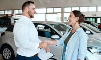 two people shaking hands at auto dealership graphic