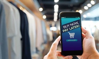a man holding a smartphone with buy now pay later displayed graphic a man holding a smartphone with buy now pay later displayed graphic