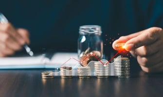 a man stacking coins graphic