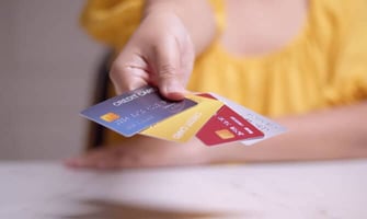 a woman holding credit cards graphic a woman holding credit cards graphic