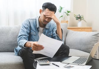 man looking at credit card debt graphic man looking at credit card debt graphic