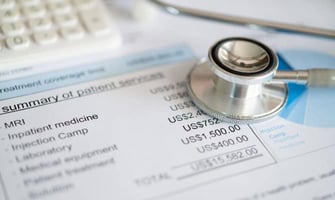 a stethoscope on a medical bill graphic a stethoscope on a medical bill graphic