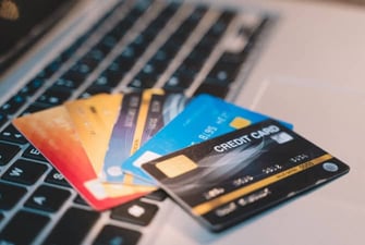 credit cards on top of a laptop keyboard graphic credit cards on top of a laptop keyboard graphic