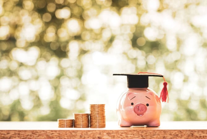 a piggy bank with graduate cap and coins graphic a piggy bank with graduate cap and coins graphic