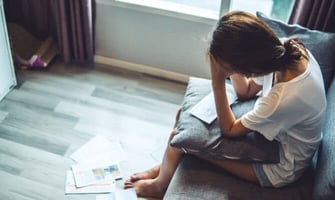 a young woman stressed over bills graphic