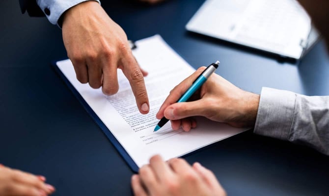 a person signing a contract graphic
