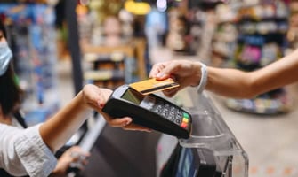a woman paying with a card at a store graphic