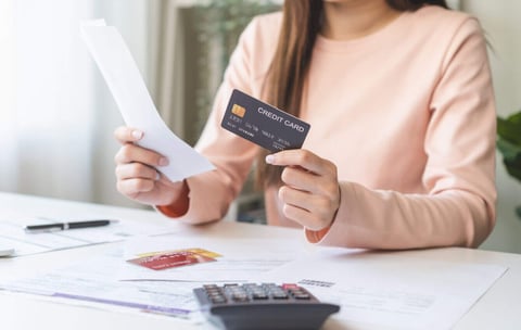 woman holding a credit card graphic