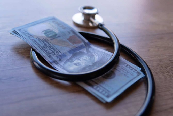 a dollar bills wrapped by a stethoscope graphic a dollar bills wrapped by a stethoscope graphic