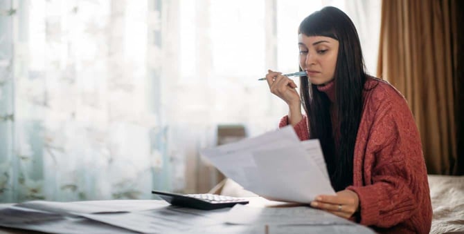 Photo of Woman Looking at Bills