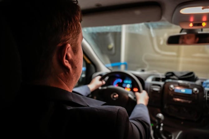 Photo of Man Driving Car Over The Shoulder