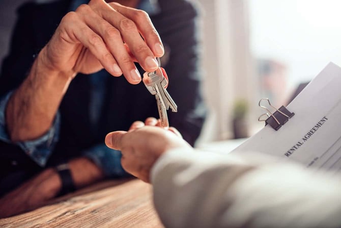 Landlord Handing Keys To Renter Landlord Handing Keys To Renter
