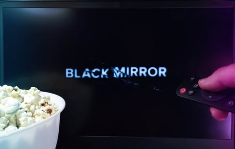 Photo of TV showing episode of "Black Mirror" Photo of TV showing episode of "Black Mirror"