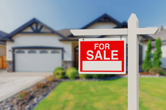 For Sale sign in front of house